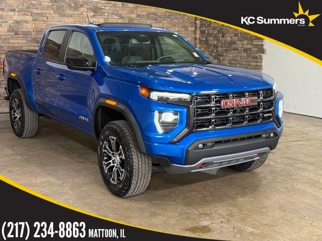 2023 GMC Canyon Crew Cab Short Box 4-Wheel Drive AT4 in Dynamic Blue Metallic — front three-quarter view